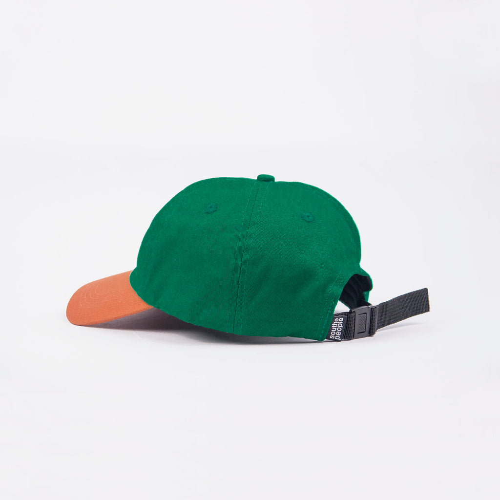 Trasera gorra color verde con visera camel logo south people